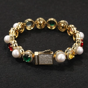 Detailed close-up of a gold bracelet with white pearls and colorful faceted gemstones