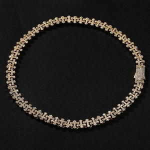 Close-up of hip hop gold plated cross necklace featuring iced out white zircon stones