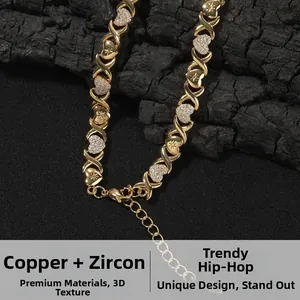 Close-up of gold-plated XO bracelet with heart links inlaid with sparkling cubic zirconia