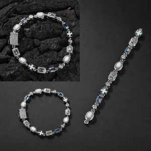 Detail of 6mm opal bracelet with blue square zircon and paved cross charm charms