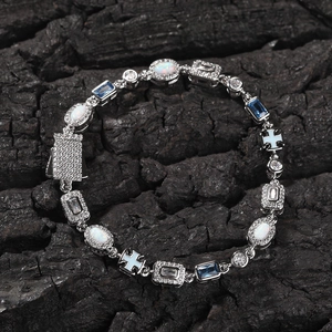 Detailed macro view of opal and blue gemstone bracelet with silver cross and buckle