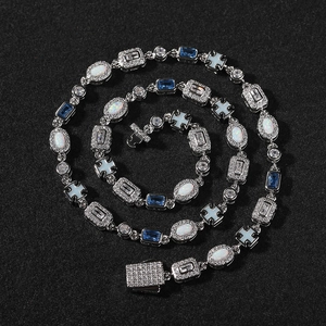 Detailed macro view of an opal and blue gemstone bracelet with a diamond clasp