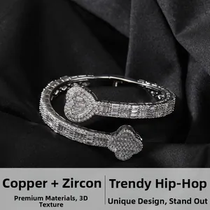 Detail of hip hop copper bangle with clover and heart motifs set in cubic zirconia