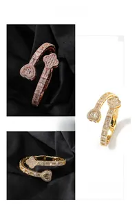 Detail view of heart and clover open bracelets with gold plating and cubic zirconia inlay