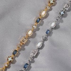 Detail shot of luxury 6mm gold and silver opal bracelets with blue gemstones and zircons