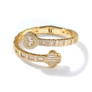 Detail of hip hop clover and heart bracelet with sparkling cubic zirconia in gold
