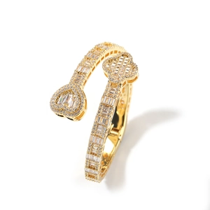 Detail of gold clover and heart bangle with cubic zirconia pave setting and 18K finish