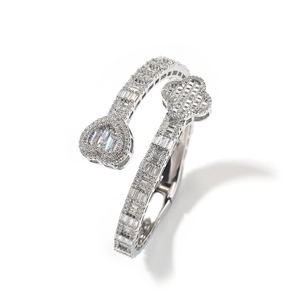 Detail of cubic zirconia paved heart and clover design on silver-colored cuff bracelet