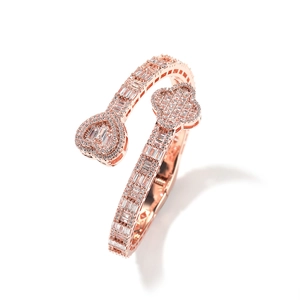 Detail view of rose gold bypass bracelet with pave-set clover and heart patterns