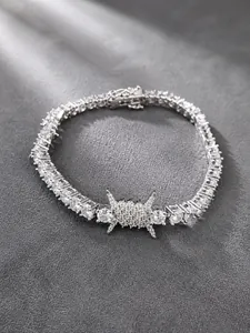 Detailed macro view of hip hop tennis bracelet with silver thorn wire design and CZ stones
