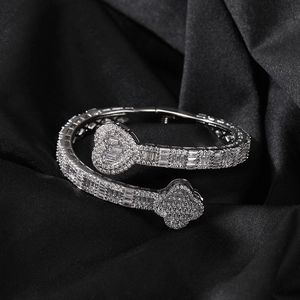 Detail of silver heart and clover bangle encrusted with shimmering cubic zirconia