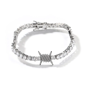 Detail of silver tennis bracelet with cubic zirconia stones and barbed wire centerpiece