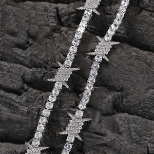 Close-up of hip hop tennis bracelet featuring barbed wire links and inlaid cubic zirconia