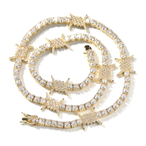 Close-up of hip hop gold tennis chain with thorn wire elements and sparkling zircons