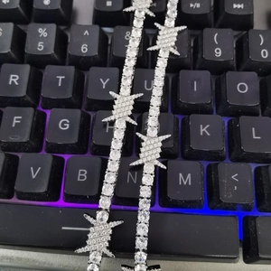 Close-up of hip-hop tennis bracelet with silver wire thorns and white zircons
