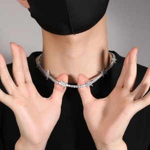 Close-up of hip-hop tennis necklace with silver thorns and shimmering white zircons