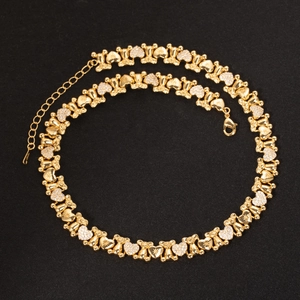 Detail of bear and heart links on gold necklace with micro-pave cubic zirconia crystals