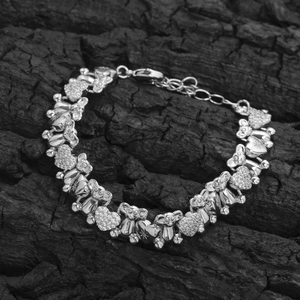 Detail of silver bear and heart link bracelet with micro-pave cubic zirconia stones