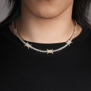 Hip hop tennis necklace with gold plated thorns and cubic zirconia on a model