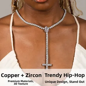 Close-up of silver-plated Y-shaped tennis necklace with a cubic zirconia cross pendant