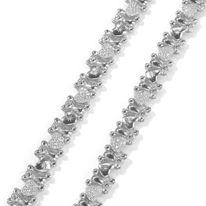 Detailed macro view of silver heart and bear links with pave zircon and star engravings