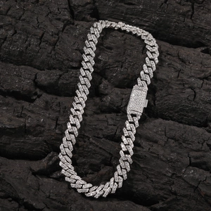 Makroaufnahme eines silbernen Panzerarmbands mit Zirkonia-Steinen auf Holzkohle-Hintergrund