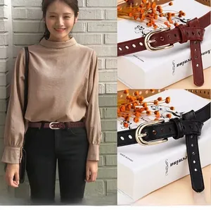 Macro detail of镂空 cutout cowhide leather belts with golden pin buckles for women
