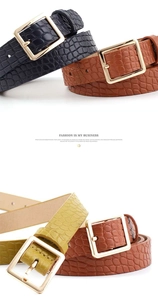Detail of crocodile embossed leather belts with polished gold square buckles in three colors