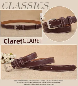 Detail of claret leather belt with white double stitching and matte silver buckle