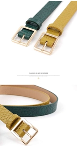 Close-up of crocodile pattern leather belts with elegant golden square metal buckles