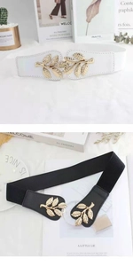 Detail view of elastic waist belts in black and white with golden leaf-shaped metal buckles
