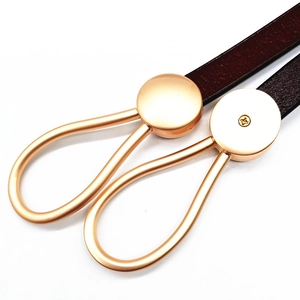 Detail of genuine leather belt with matte rose gold buckle for elegant styling