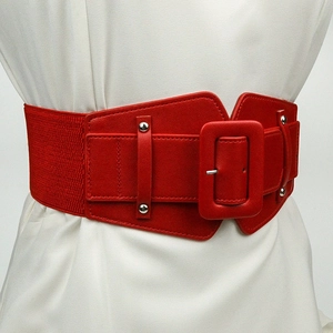 Women's wide elastic waist belt in red faux leather with large buckle and silver rivets