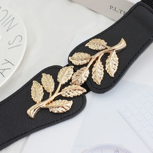 Women's black elastic waist belt with decorative gold metal leaf buckle and leather texture