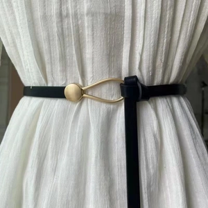 Slim black faux leather waist belt for women with elegant gold teardrop buckle detail