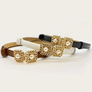 Set of three faux leather slim belts in black white and brown with pearl buckle