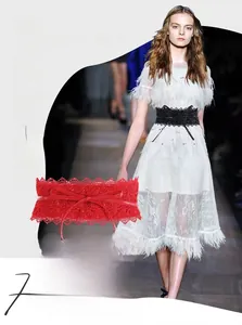 Close-up of elegant red lace waist belt with intricate hollow floral patterns and tie-up bow