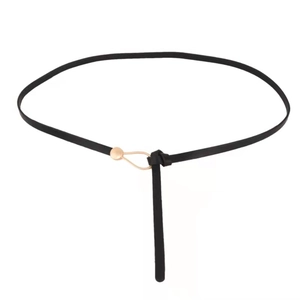 Minimalist black faux leather waist belt for women with gold metal buckle on white background