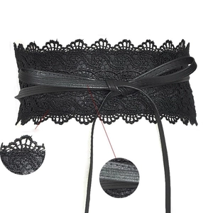 Detailed macro view showing black lace textures and faux leather lacing on the corset belt