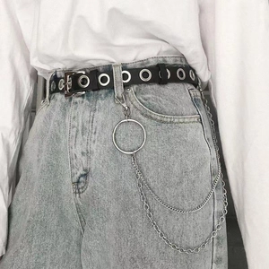 Detail of punk style wide waist belt with metal eyelets and double-layer chain accessory