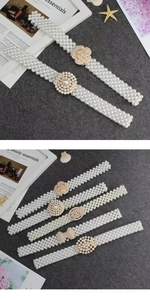 Detailed macro view of white pearl elastic belts with elegant gold floral buckle designs