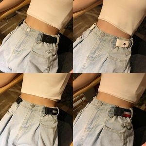 Detail of invisible elastic waist belts showing metal snaps on jeans in four colors