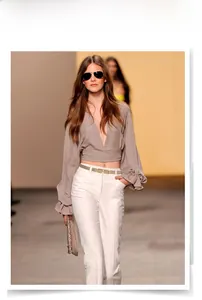 Slim leather waist belt for women styled with a summer blouse and white trousers