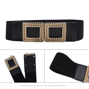 Detail of black elastic wide belt featuring a golden double square buckle with twisted rope texture