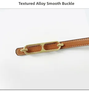 Detail of a textured alloy smooth buckle on a brown pebble leather belt for women