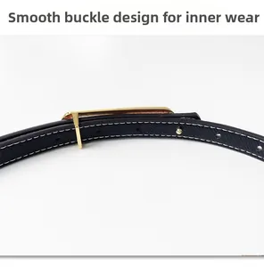 Detail view of the smooth inner-wear gold buckle design on a black cross-grain leather belt
