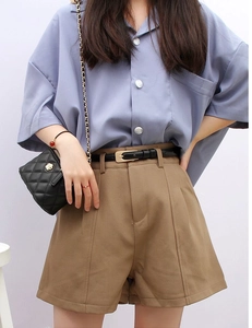 Classic black leather belt styled on khaki high-waisted shorts with a blue shirt
