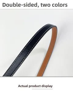 Detail of double-sided leather belt featuring Epsom texture and white contrast stitching