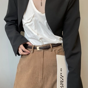 Vintage dark brown thin leather belt for women with golden buckle on khaki trousers
