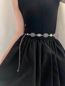 Close-up of vintage silver waist chain with spiral textured metal links and mirror inlays